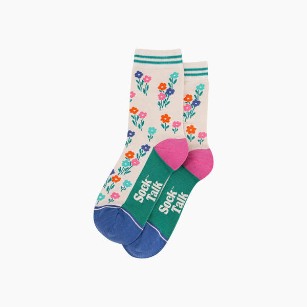 Sock Talk wildflowers bamboo socks in cream with colorful flower patterns, pink heel, and green toe with "Sock Talk" text.