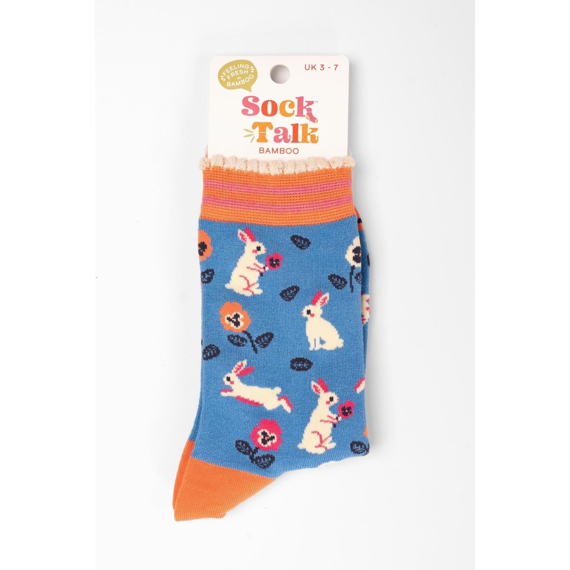 Women's blue bamboo socks featuring rabbits, flowers, and colorful patterns, with orange accents, by Sock Talk.