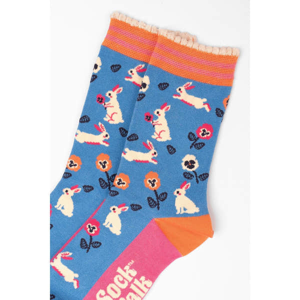 Women's blue bamboo socks with rabbit and flower print, featuring orange and pink accents, by Sock Talk.