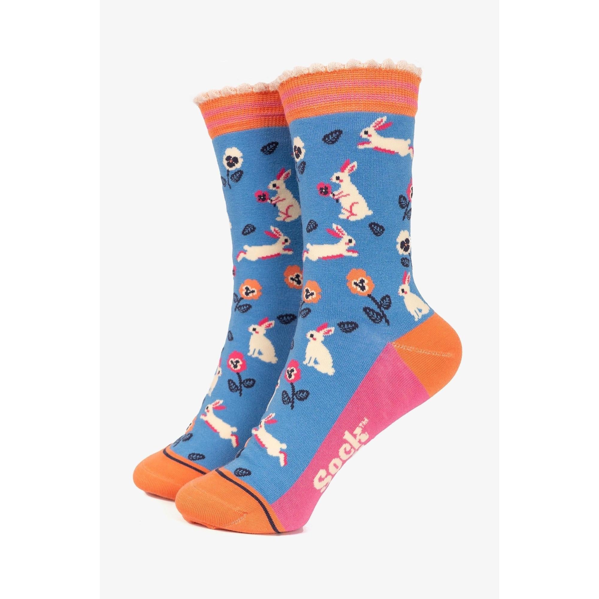 Women's blue bamboo socks with bunny, flower, and leaf patterns, orange toe and heel, 