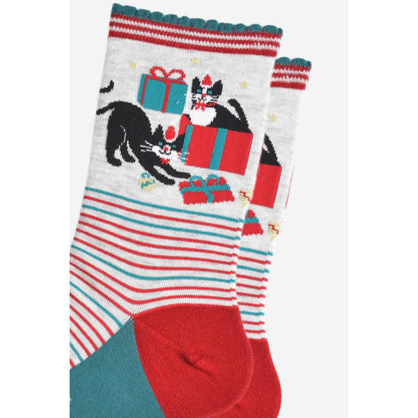 Women's Christmas bamboo socks with grey, red, and teal stripes, featuring cats, presents, and holiday-themed designs.
