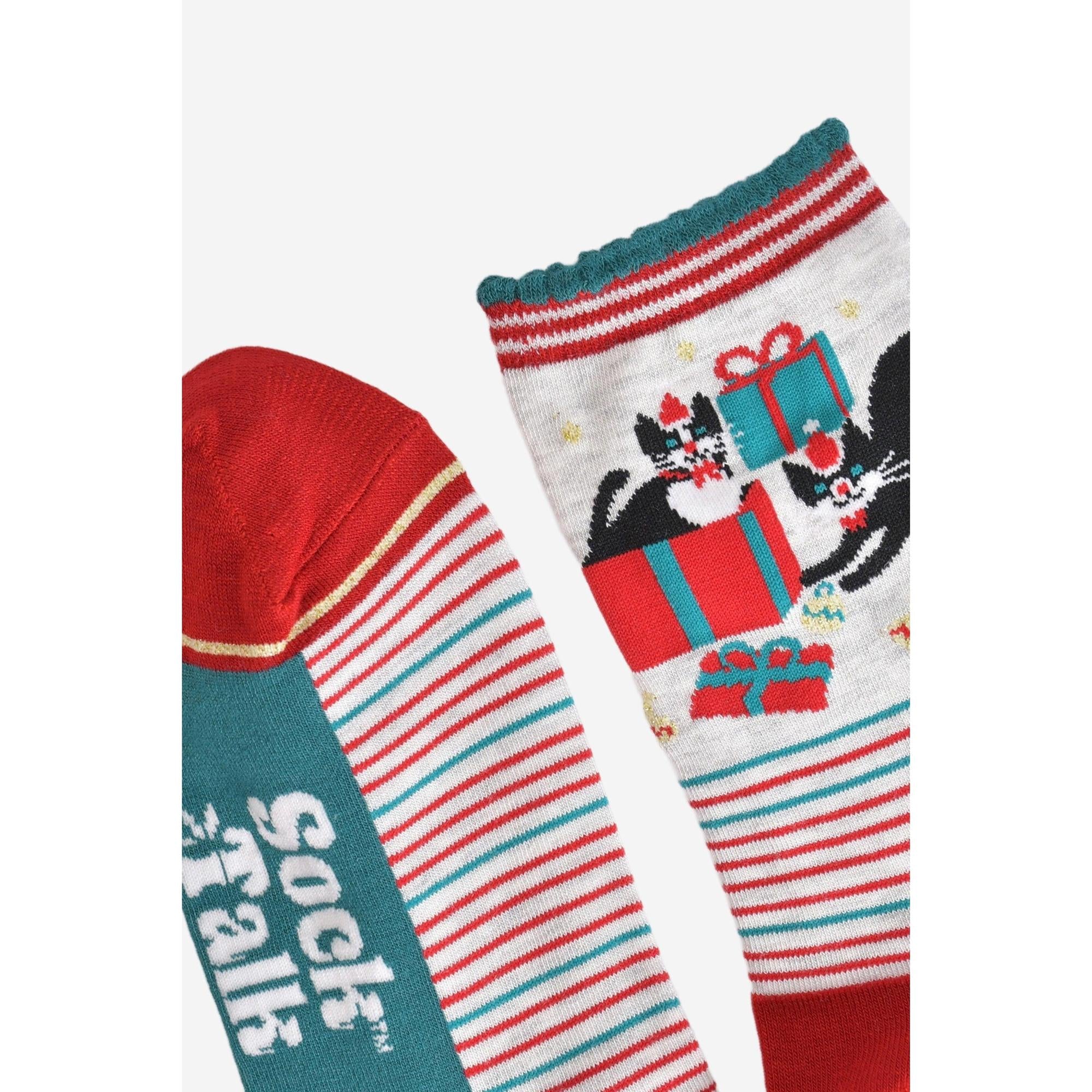 Women's bamboo Christmas socks with grey and red background featuring black cats with presents and festive holiday design.