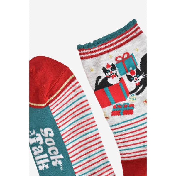 Women's bamboo Christmas socks with grey and red background featuring black cats with presents and festive holiday design.