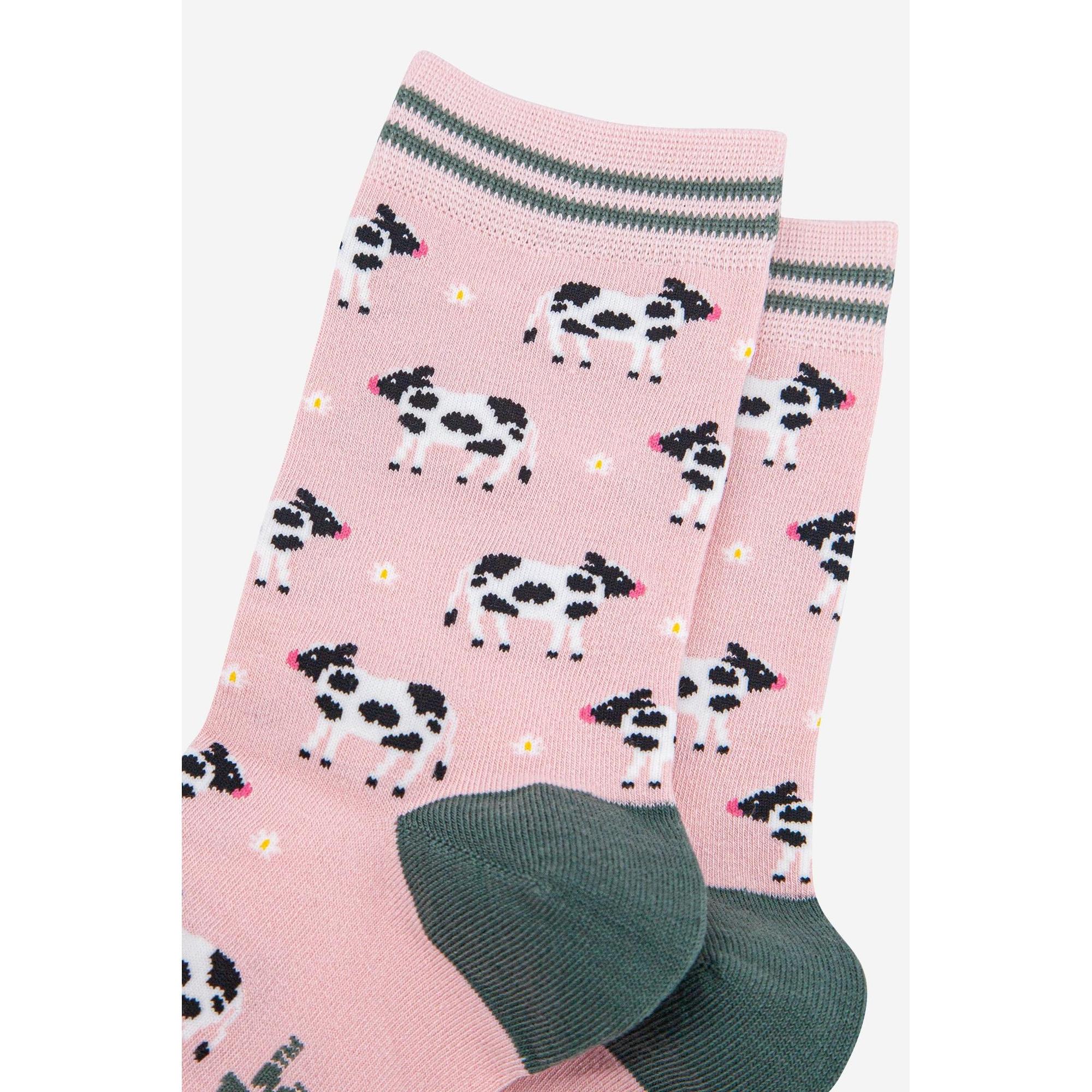 Women's pink bamboo socks with black and white cow print, yellow dots, and gray accents, perfect for spring.