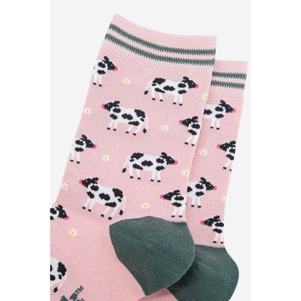 Women's pink bamboo socks with black and white cow print, yellow dots, and gray accents, perfect for spring.