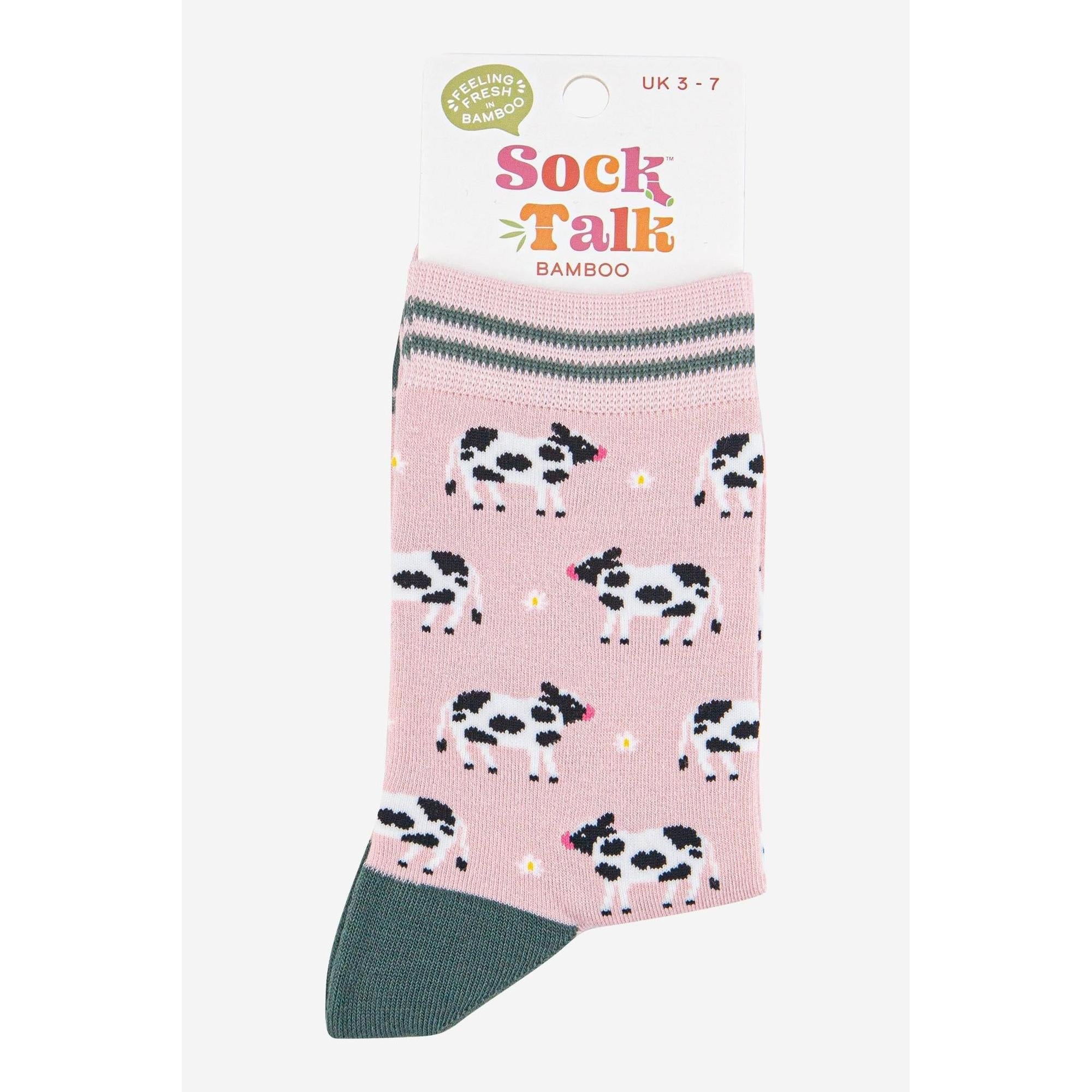 Pink bamboo women's socks with black and white cow print design and gray striped cuff.