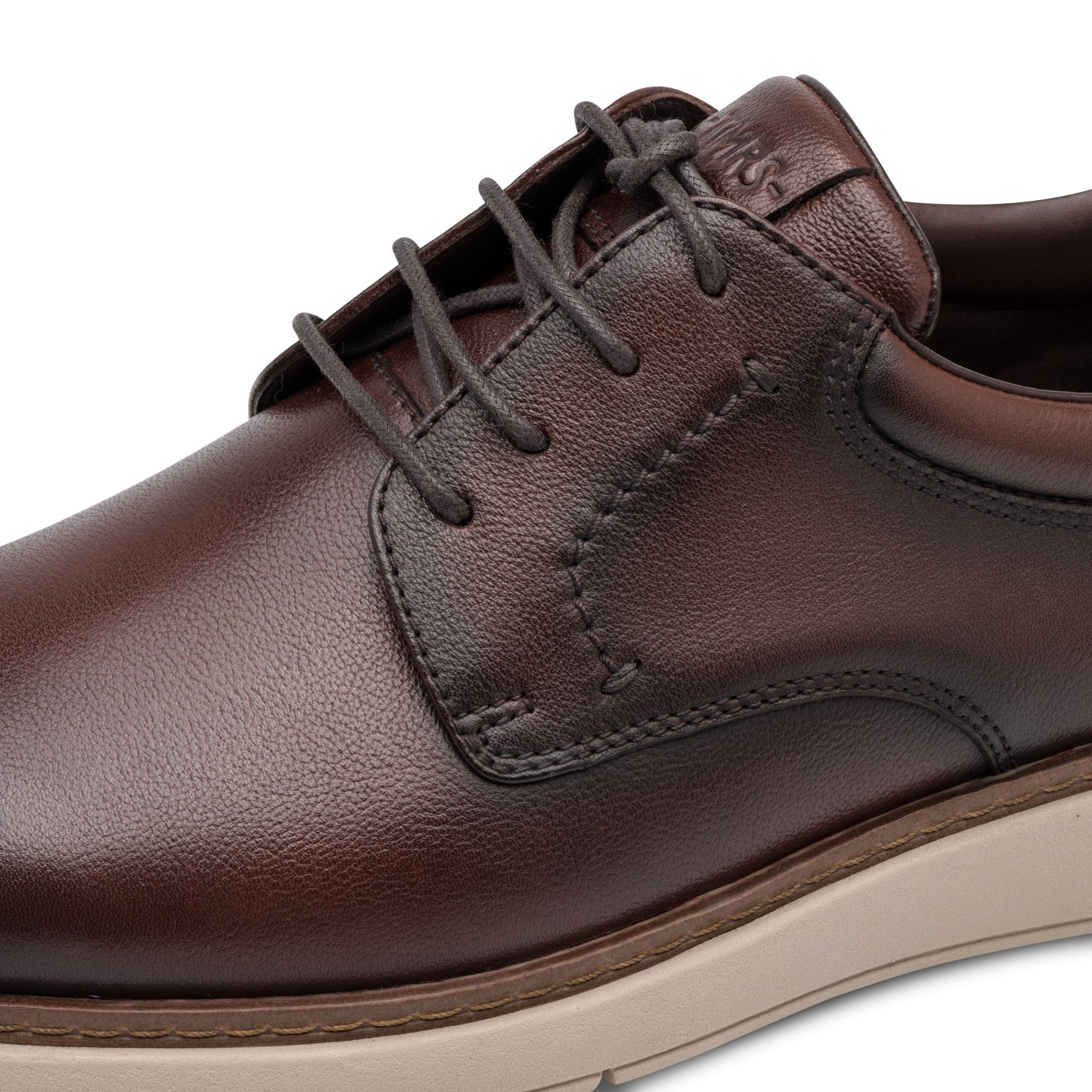 Close-up of the mocca brown Tamaris lace-up shoe showing the leather texture, stitching and lace eyelets.