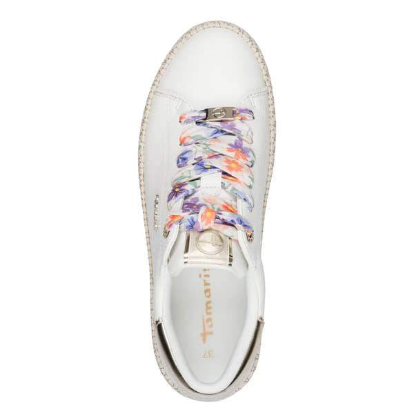 White lace-up sneaker with floral patterned laces, metallic accents, and a woven sole detail.