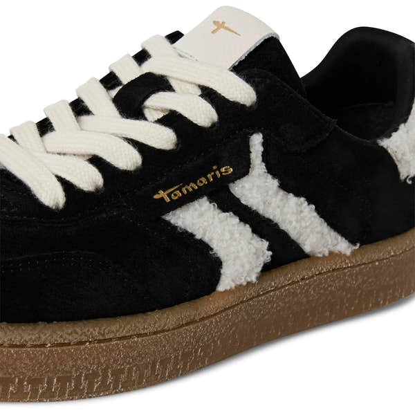 Tamaris ladies black and white lace-up trainers with fur accents and a brown rubber sole.