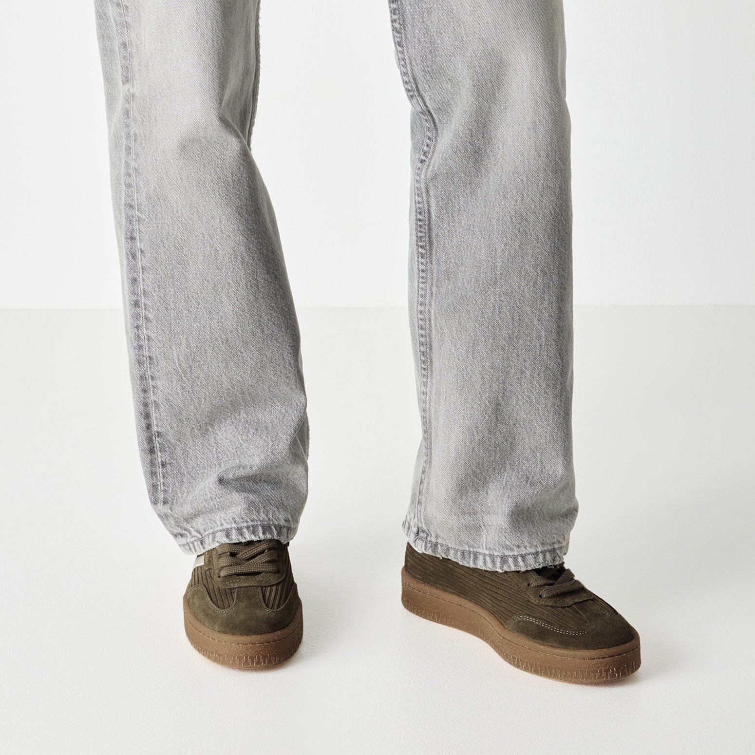 Olive tamaris lace-up trainer worn on foot, side view.