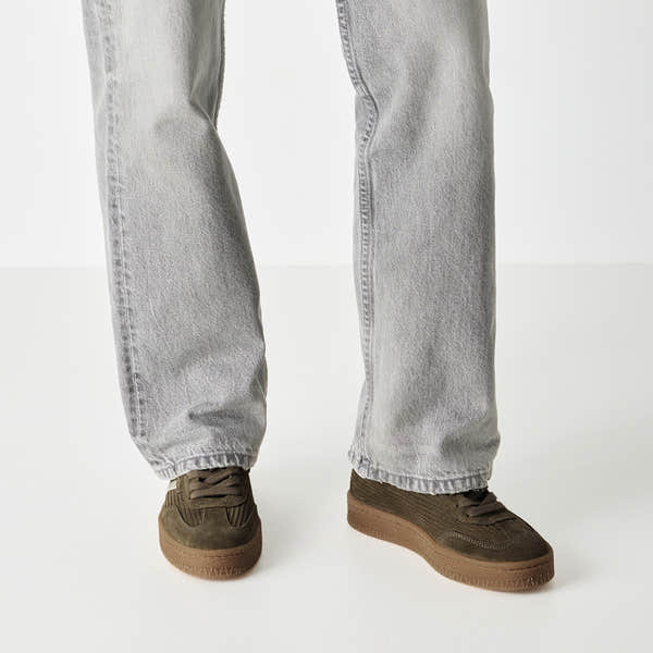 Olive tamaris lace-up trainer worn on foot, side view.