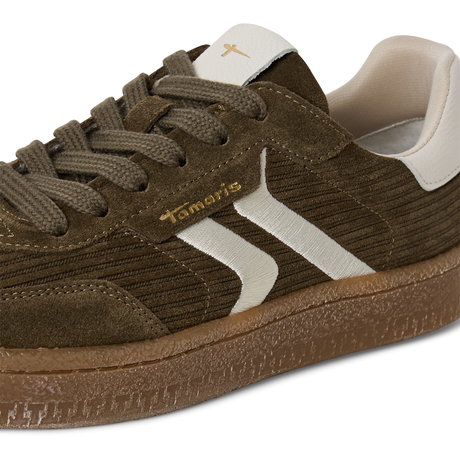 Close-up of the olive Tamaris lace-up trainer showing the mixed leather panels, stitching and trim.