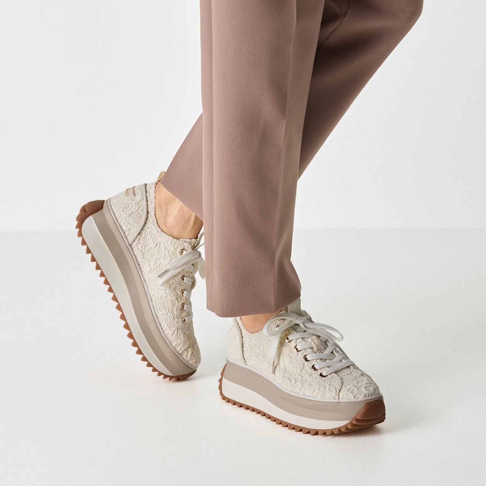 Women’s ivory textile lace-up shoes with a chunky platform sole and brown rugged outsole.