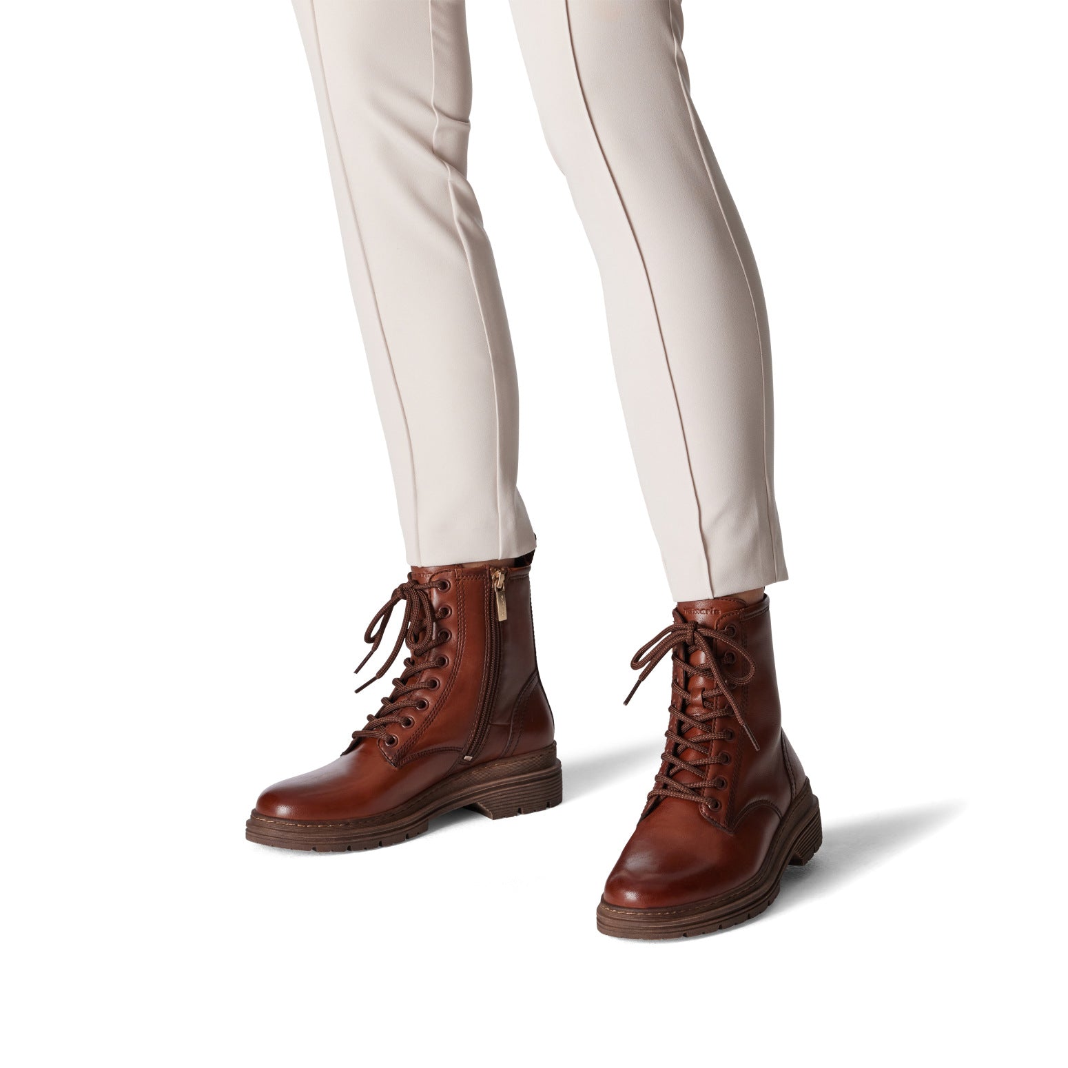 Tamaris Ladies Muscat Leather Zip & Lace Ankle Boots in brown with side zipper and lace-up front, styled with white trousers.