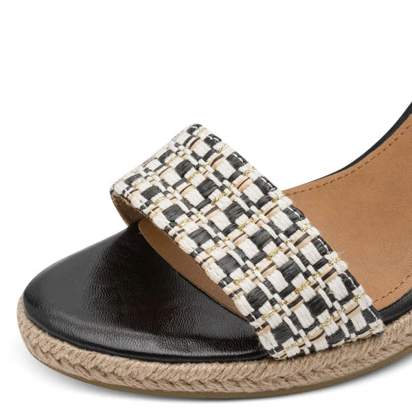 Tamaris women's black and beige textile slip-on wedge sandals with buckle detail and woven strap.