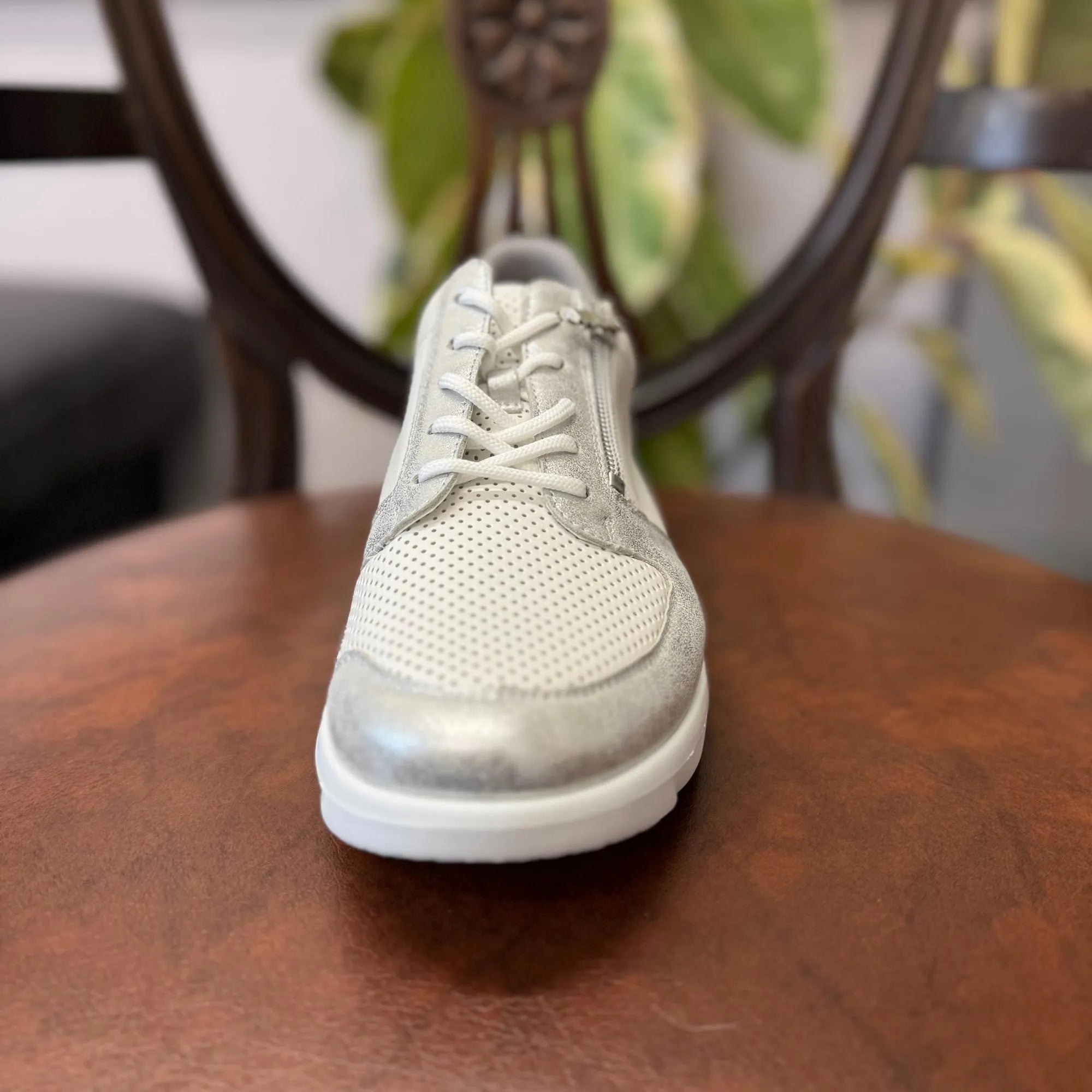 Waldlaufer 668K02 women’s wide-fit silver and white leather trainer with zip, laces, and arch support, on a wooden surface.