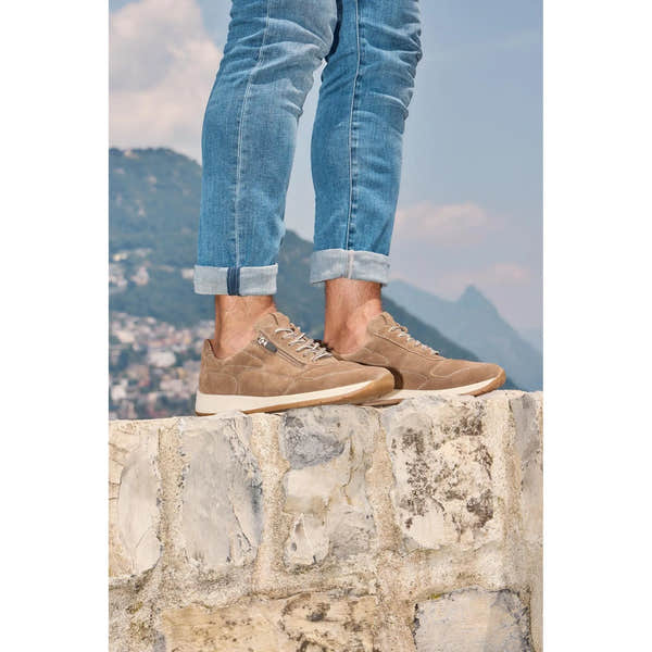 Waldlaufer men's wide brown nubuck arch support shoes with zip and lace closure, casual footwear on a stone ledge.