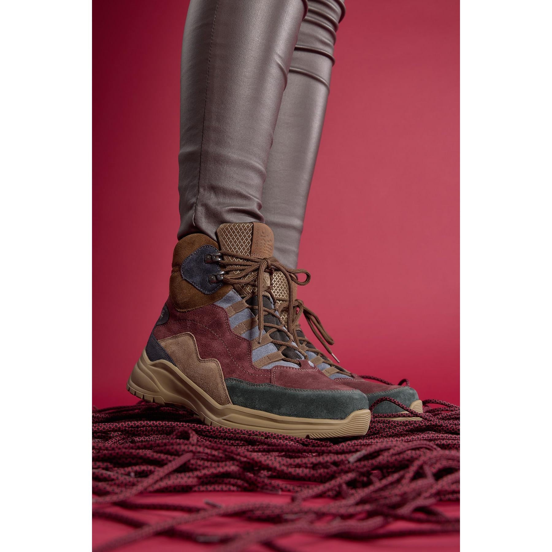 Waldlaufer women's waterproof multi-colored suede ankle boots with arch support and lace-up front, on a red background.