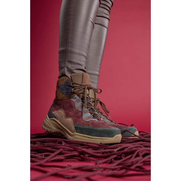 Waldlaufer women's waterproof multi-colored suede ankle boots with arch support and lace-up front, on a red background.