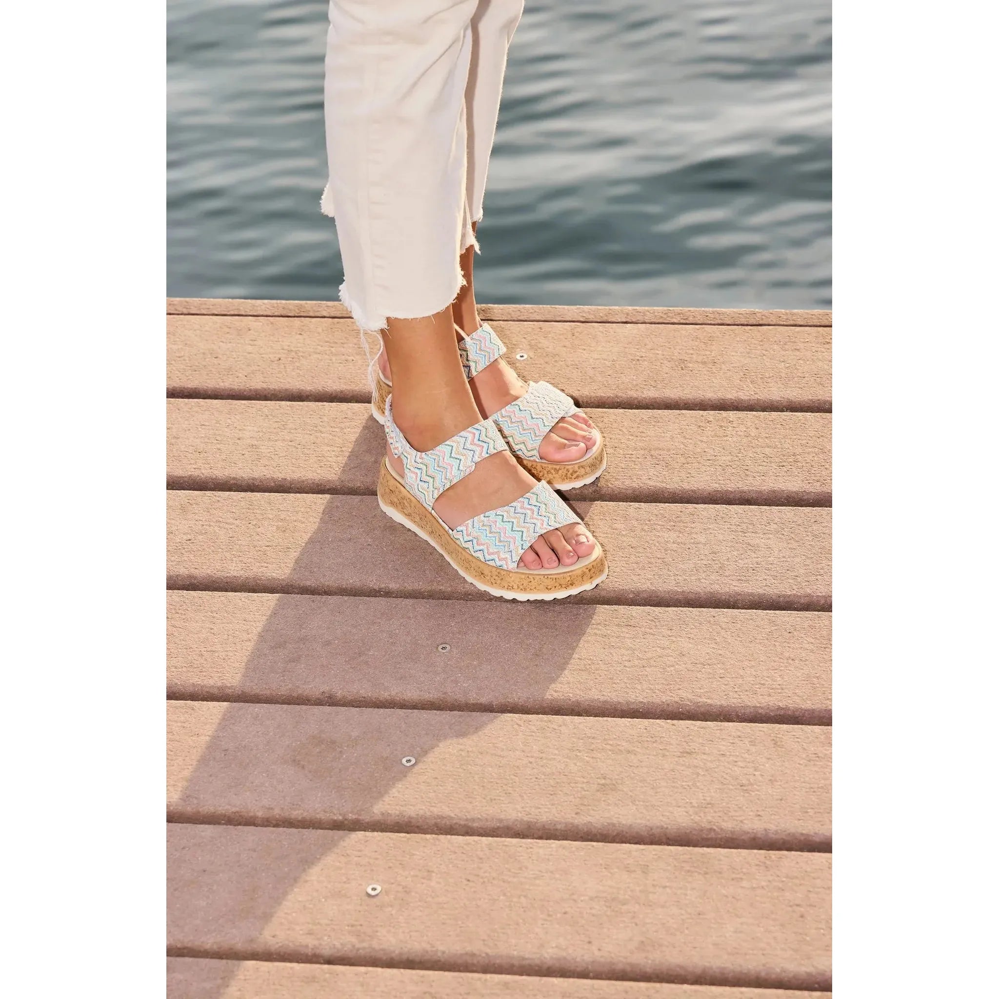 Waldlaufer H-Libby ladies' wide multi-leather touch fastening sandals with zigzag patterned straps, worn by a person near water.