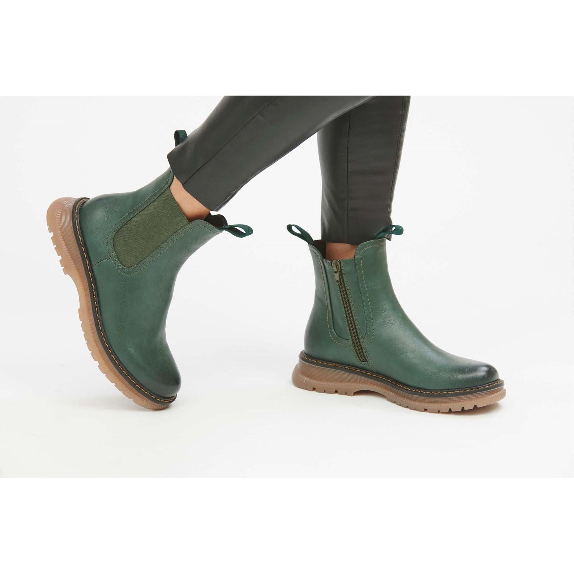 Women’s green vegan side zip ankle boots with chunky beige rubber sole and pull tabs, stylish and cruelty-free footwear.