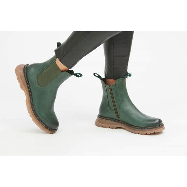 Women’s green vegan side zip ankle boots with chunky beige rubber sole and pull tabs, stylish and cruelty-free footwear.