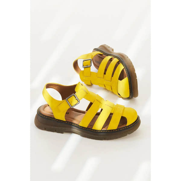 Yellow leather sandals with touch fastening straps, brown sole, and buckle detail for women.
