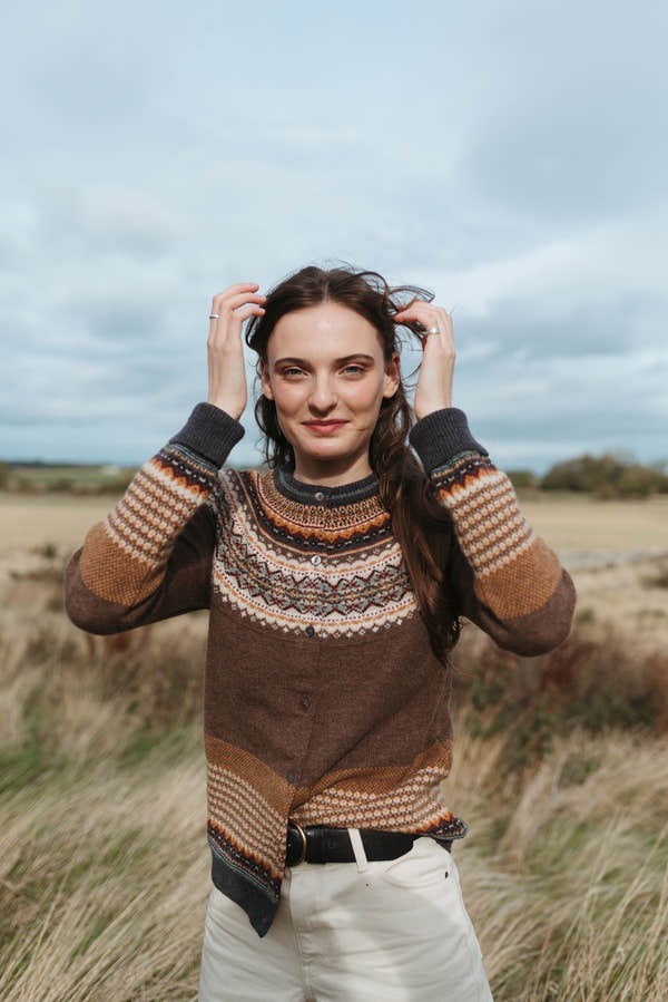 Eribé Alpine Cardigan in Hazel, model wearing the knit outdoors