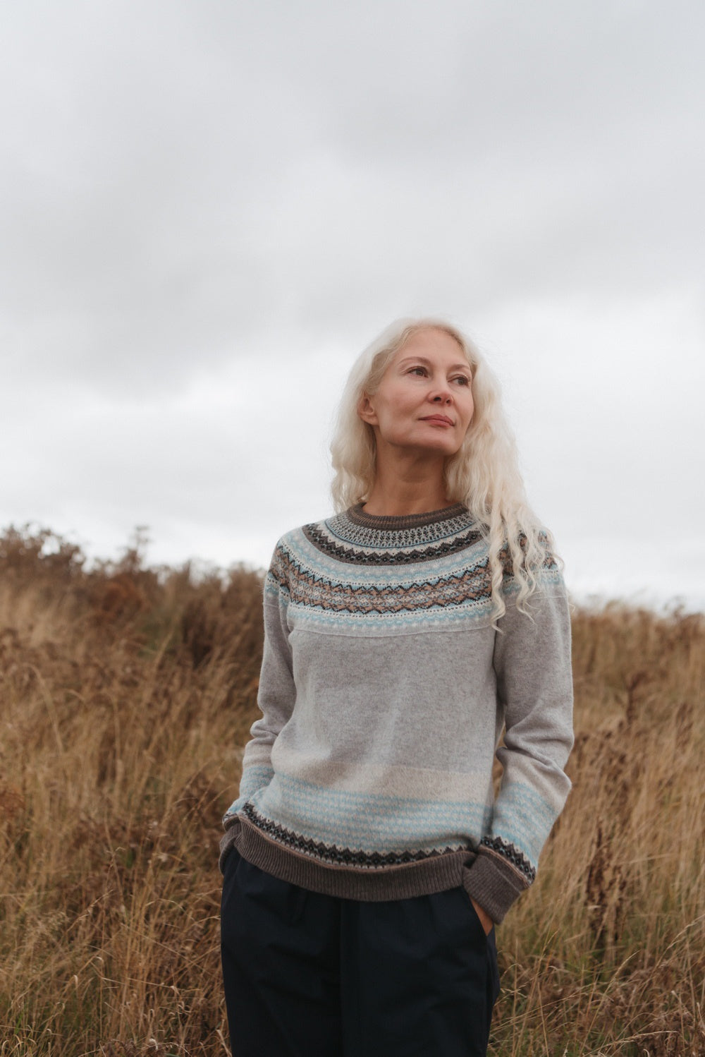 Eribé Alpine Sweater in Grace, model wearing the knit outdoors