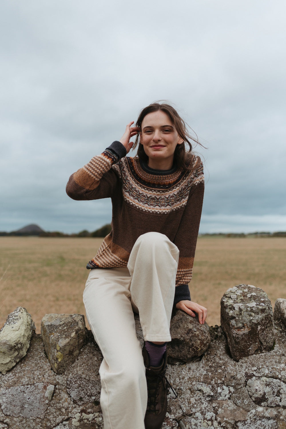 Eribé Alpine Sweater in Hazel, model wearing the knit outdoors