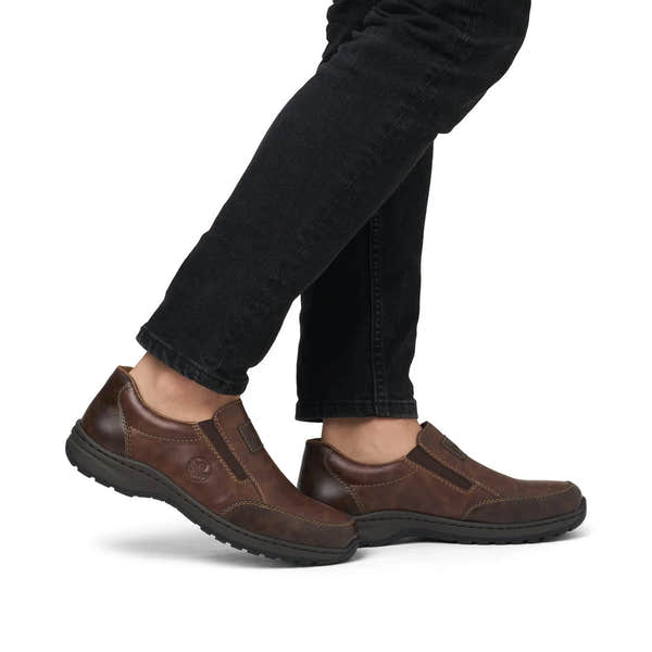 Rieker 03354-26 men's brown leather slip on shoes, on-foot lifestyle view.