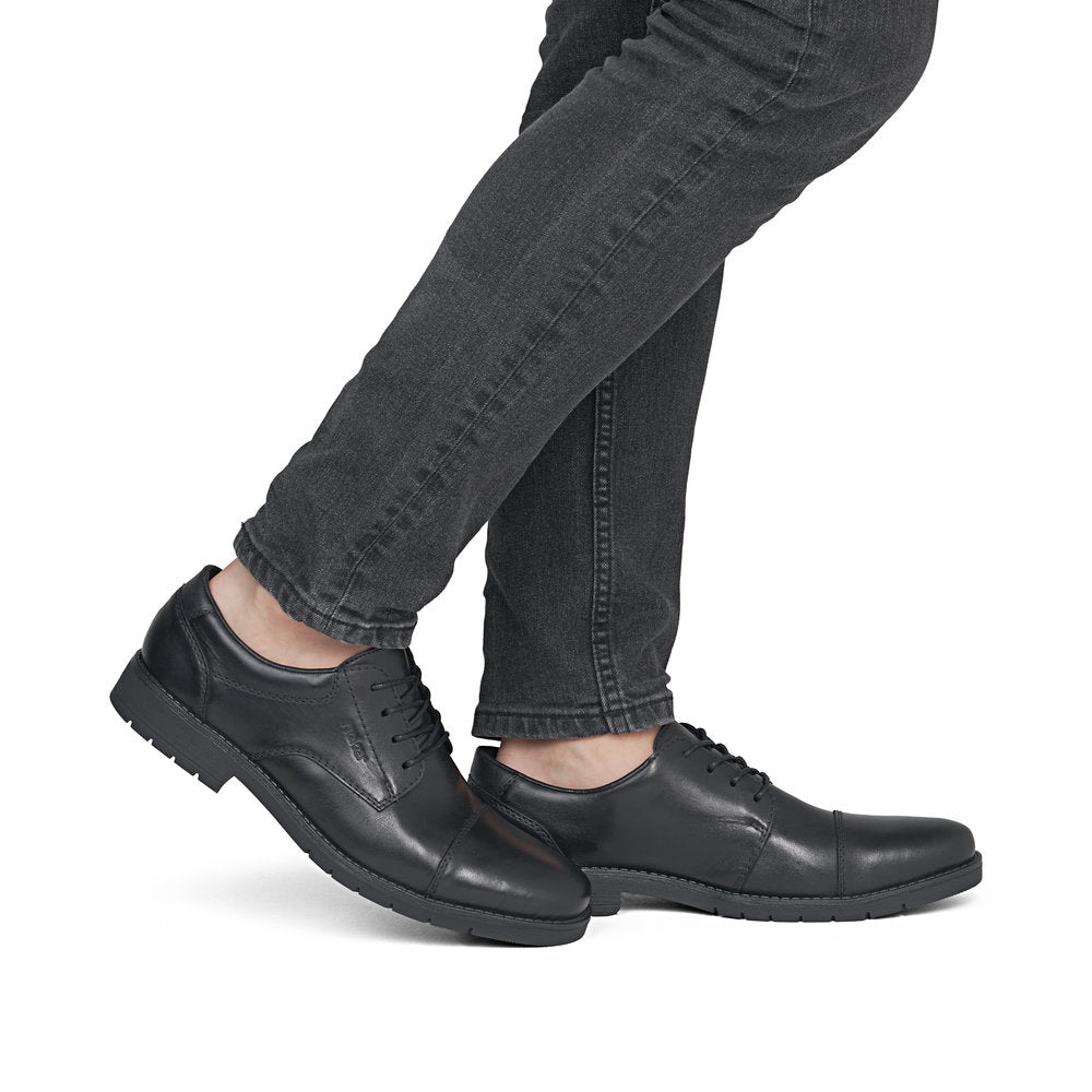 Rieker 13901-00 men's wide black leather lace up shoes, on-foot lifestyle view.