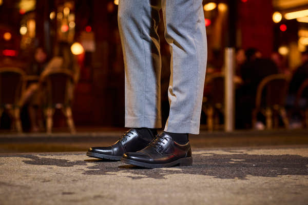 Rieker 13901-00 men's wide black leather lace up shoes, lifestyle view 5 of 10.