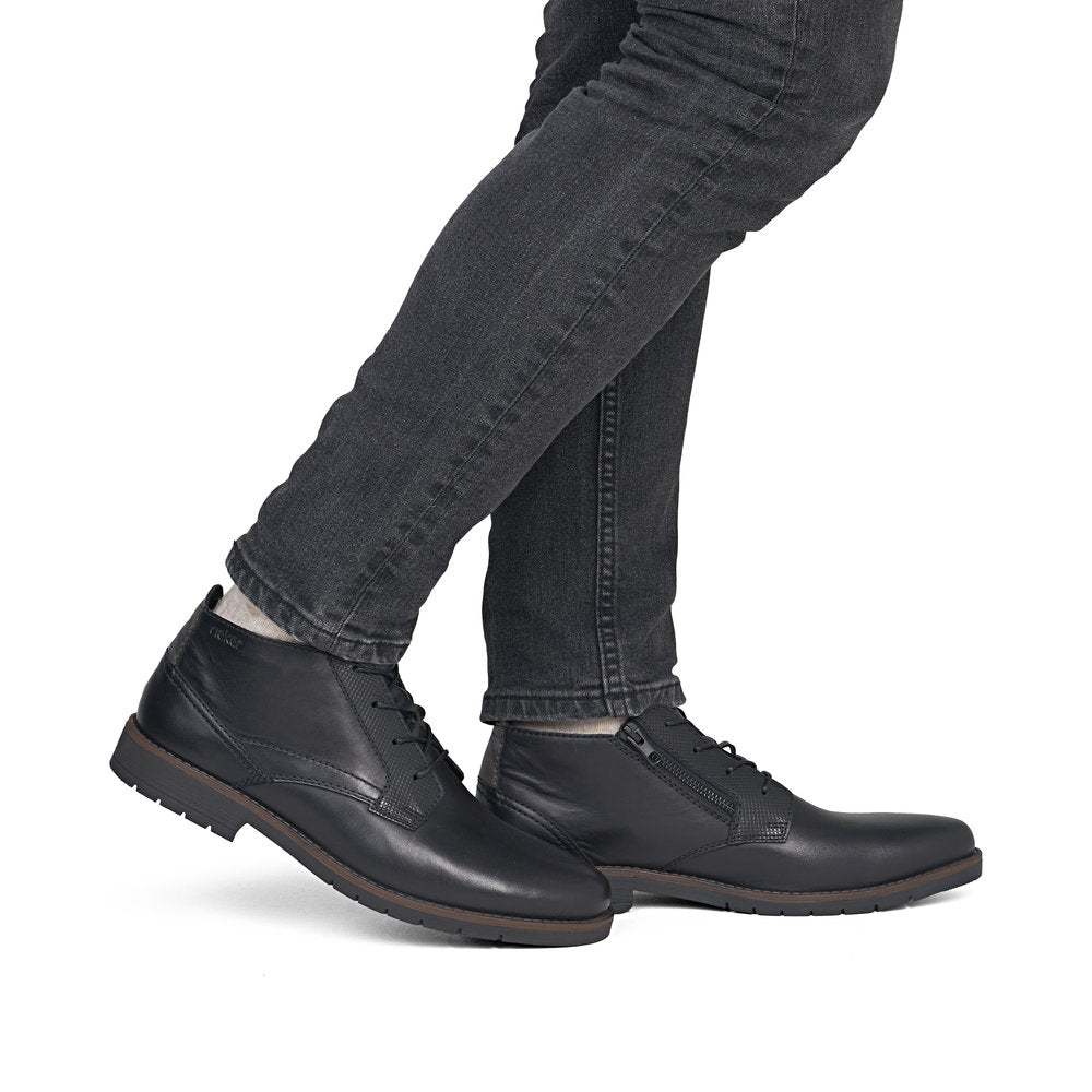 Rieker 13902-00 men's wide black leather zip & lace ankle boots, on-foot lifestyle view.