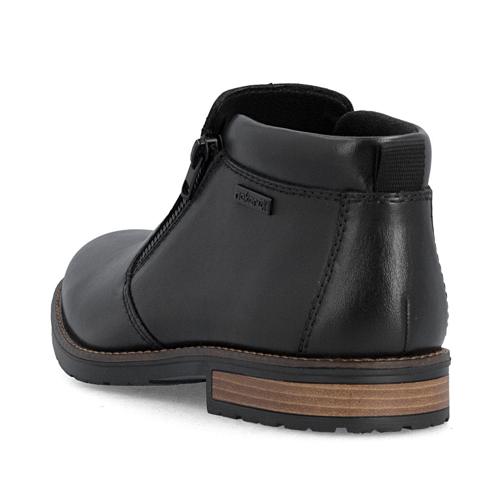 Rieker 14656-00 men's wide black leather water resistant side zip ankle boots, rear three-quarter view.