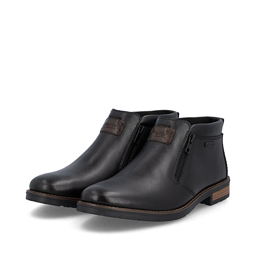 Rieker 14656-00 men's wide black leather water resistant side zip ankle boots, paired three-quarter view.