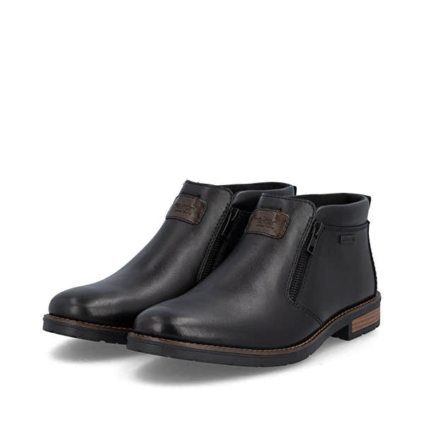 Rieker 14656-00 men's wide black leather water resistant side zip ankle boots, paired three-quarter view.