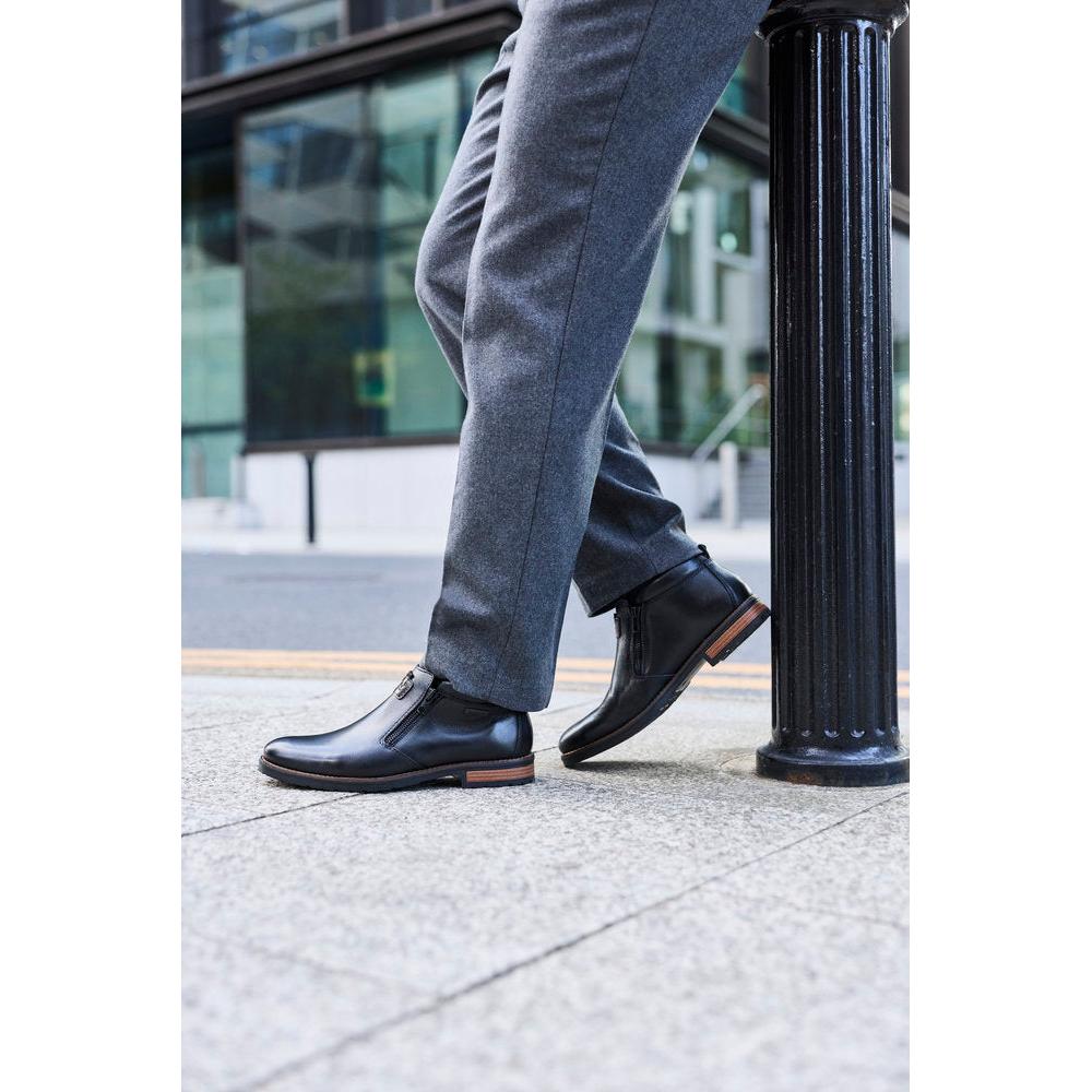 Rieker 14656-00 men's wide black leather water resistant side zip ankle boots, lifestyle view 4 of 9.