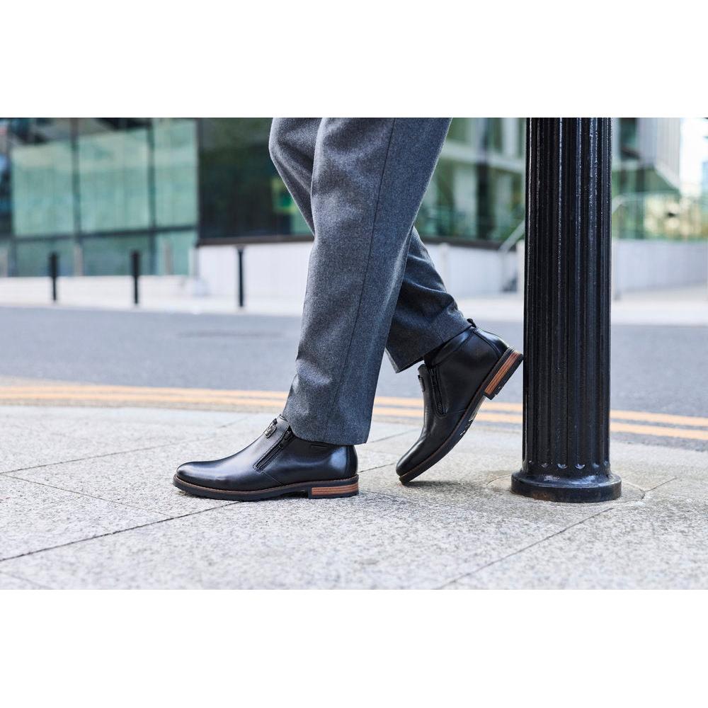 Rieker 14656-00 men's wide black leather water resistant side zip ankle boots, lifestyle view 5 of 9.