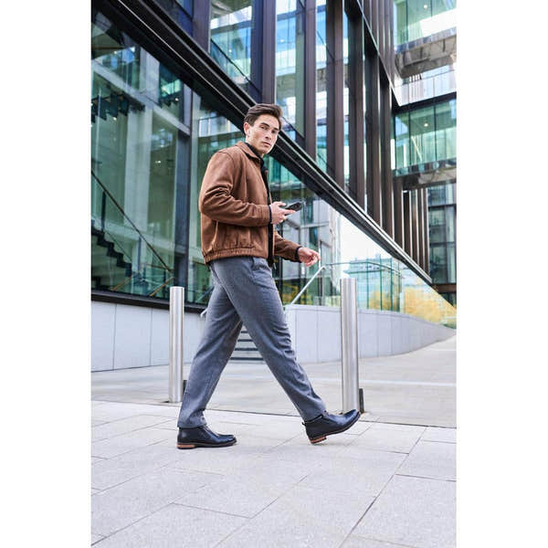 Rieker 14656-00 men's wide black leather water resistant side zip ankle boots, lifestyle view 6 of 9.