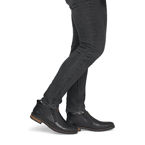 Rieker 14656-00 men's wide black leather water resistant side zip ankle boots, on-foot lifestyle view.