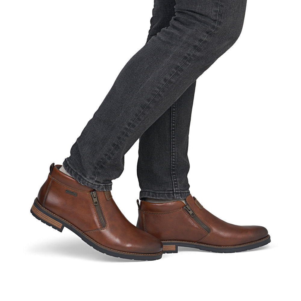 Rieker 14656-24 men's wide brown leather water resistant side zip ankle boots, on-foot lifestyle view.