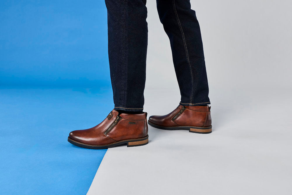 Rieker 14656-24 men's wide brown leather water resistant side zip ankle boots, lifestyle view 5 of 6.