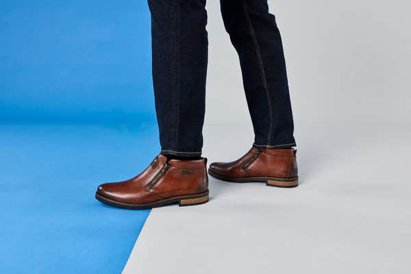 Rieker 14656-24 men's wide brown leather water resistant side zip ankle boots, lifestyle view 5 of 6.