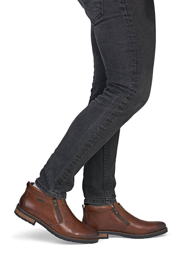Rieker 14656-24 men's wide brown leather water resistant side zip ankle boots, on-foot lifestyle view.