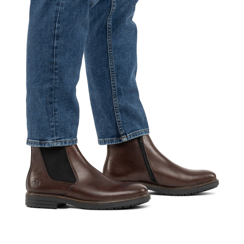 Rieker 33180-26 men's brown leather side zip ankle boots, on-foot lifestyle view.