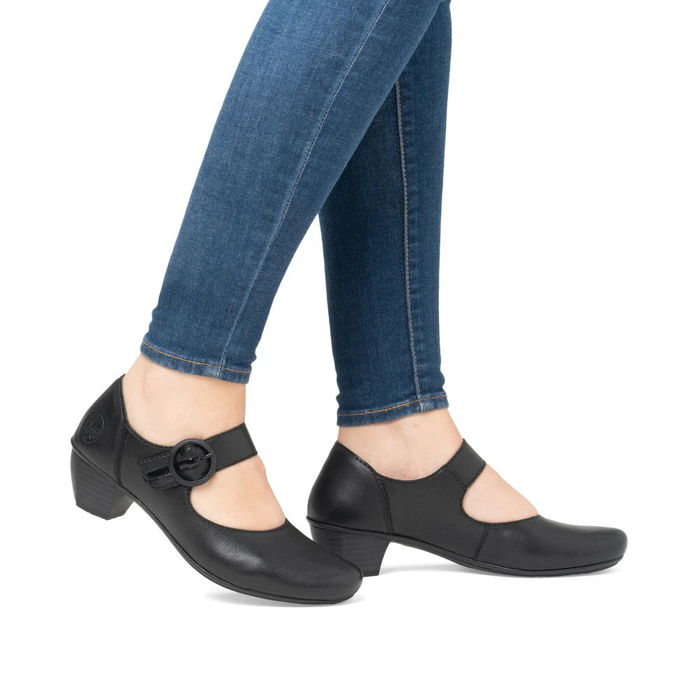Rieker 41756-00 women's black leather buckle heels, on-foot lifestyle view.