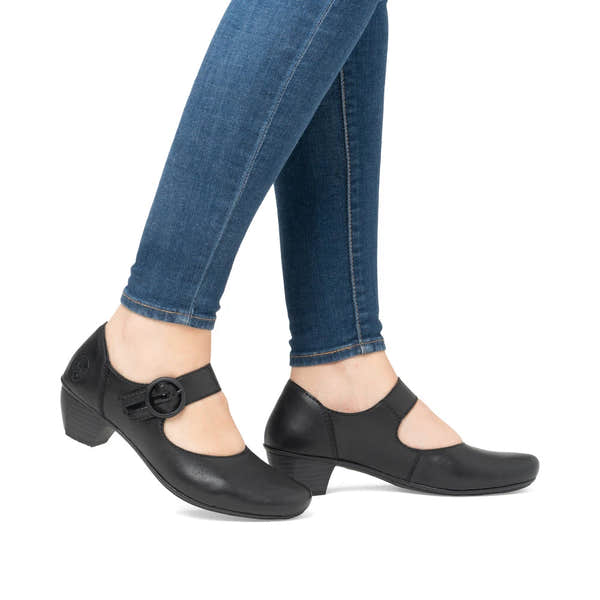 Rieker 41756-00 women's black leather buckle heels, on-foot lifestyle view.