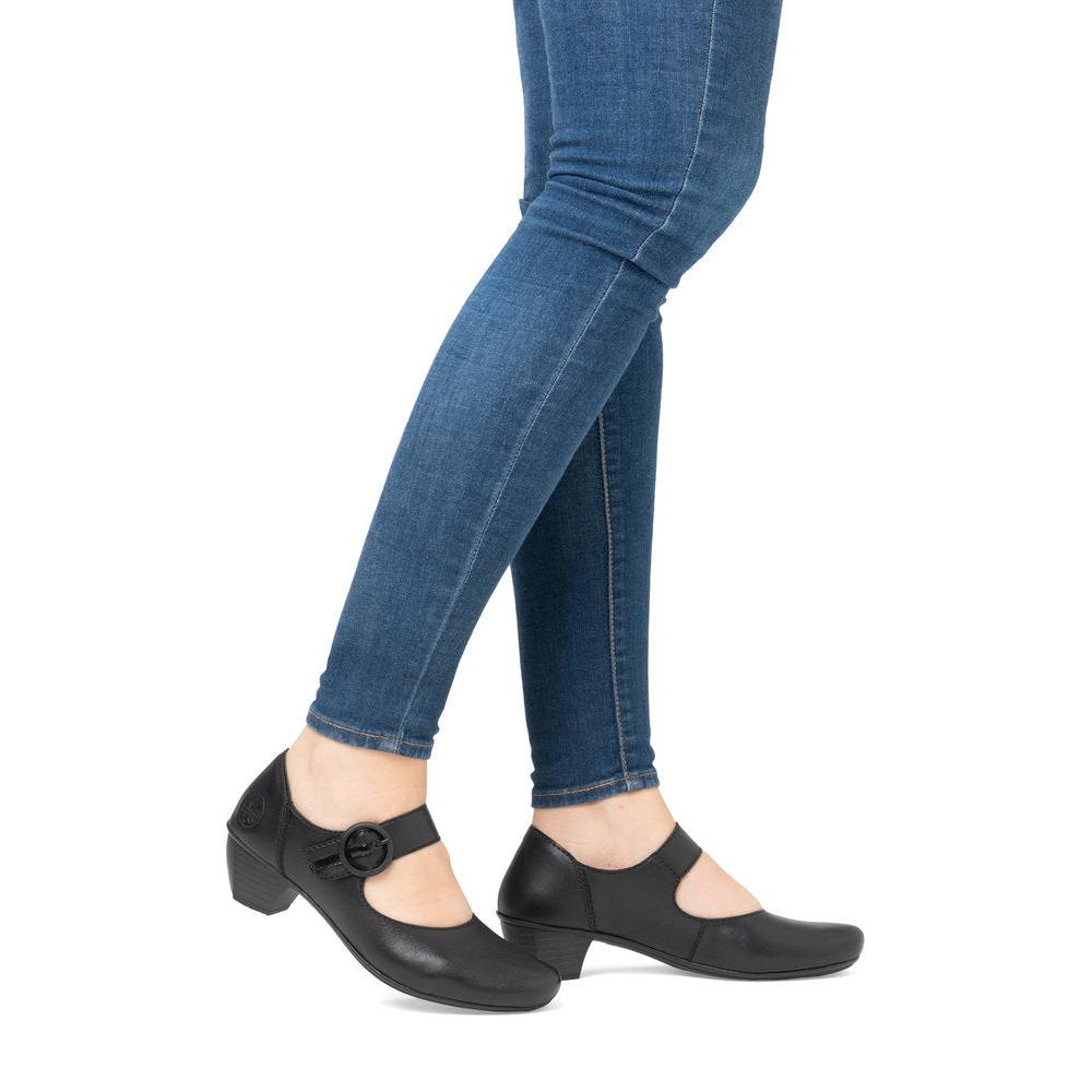 Rieker 41756-00 women's black leather buckle heels, on-foot lifestyle view.