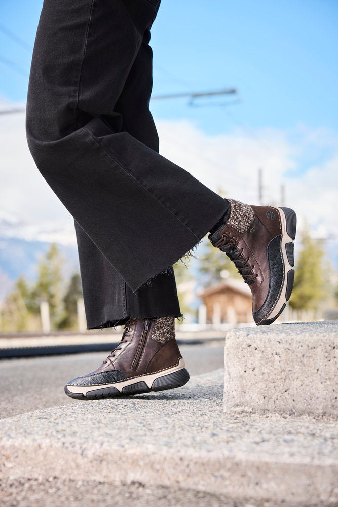 Rieker 45956-25 women's multi water resistant zip & lace ankle boots, lifestyle view 11 of 11.